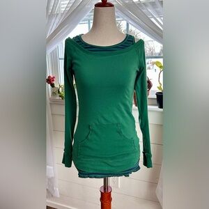 Y2K Eyelash Couture green off-the-shoulder top with attached striped underlayer.